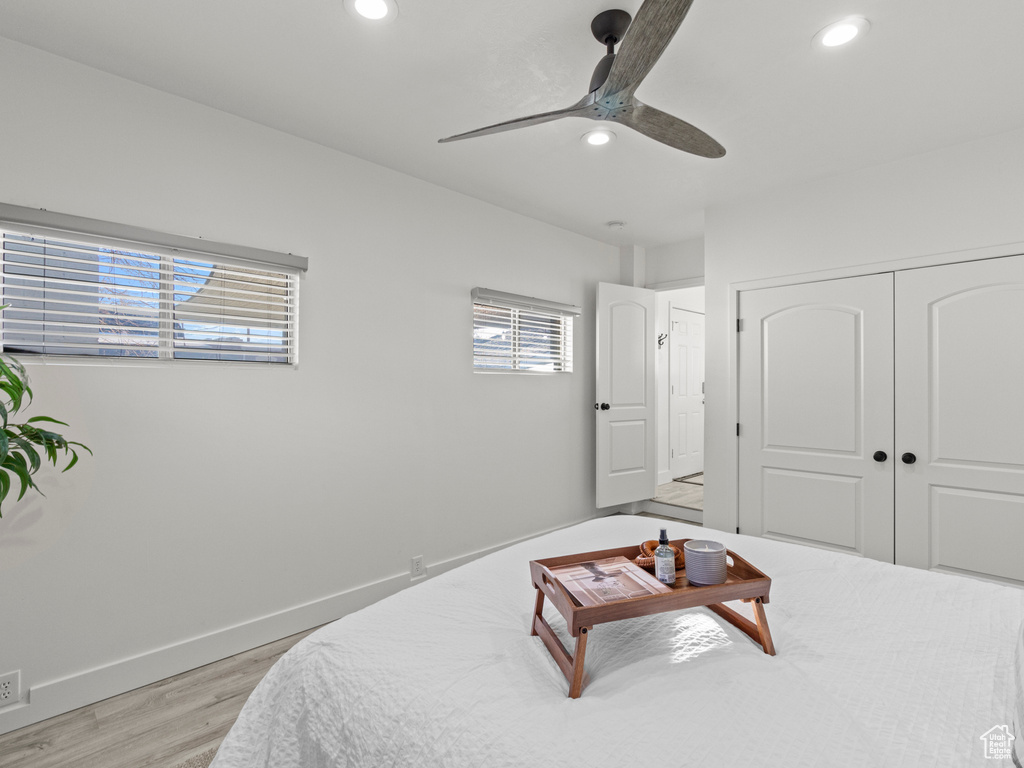 Bedroom featuring light wood-style floors, baseboards, a closet, and recessed lighting