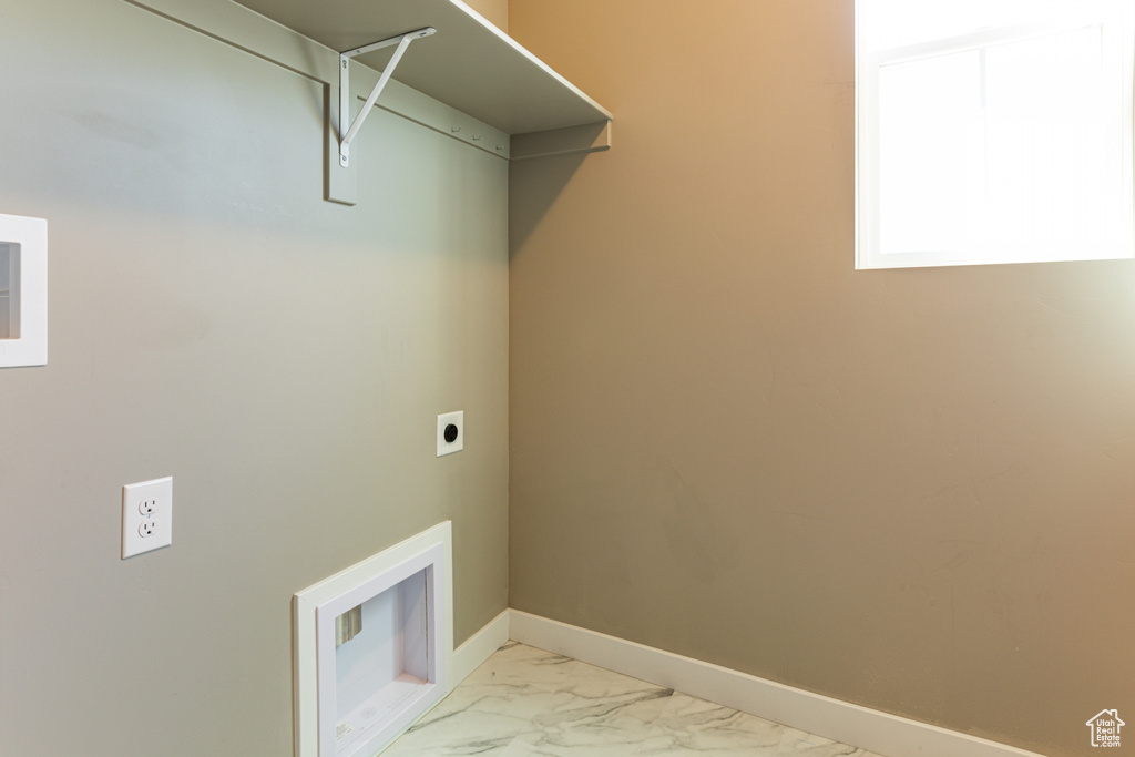 Laundry room featuring marble finish floor, hookup for an electric dryer, baseboards, and laundry area
