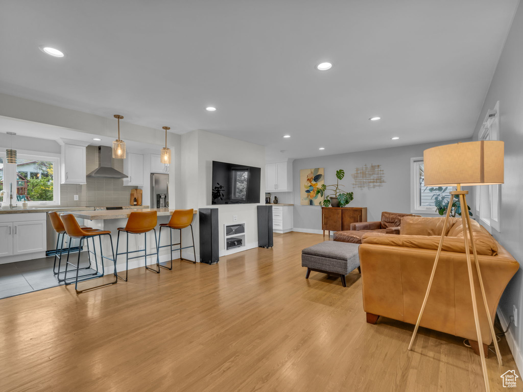 Living room featuring recessed lighting, baseboards, and light wood finished floors