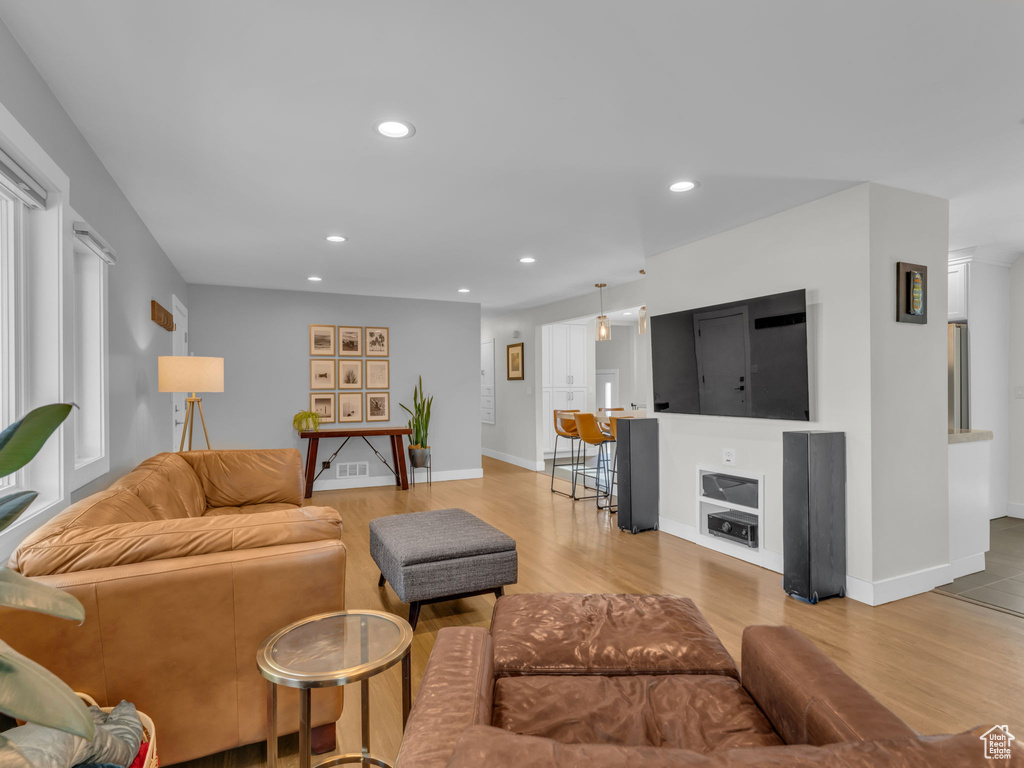 Living area with recessed lighting, baseboards, and wood finished floors