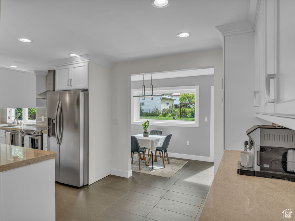 Kitchen featuring appliances with stainless steel finishes, a chandelier, white cabinetry, recessed lighting, and dark tile patterned flooring
