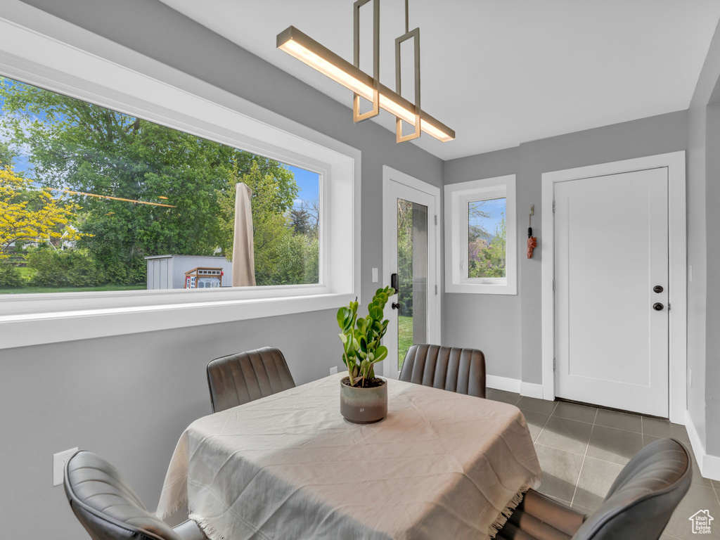 Dining space with baseboards and tile patterned flooring