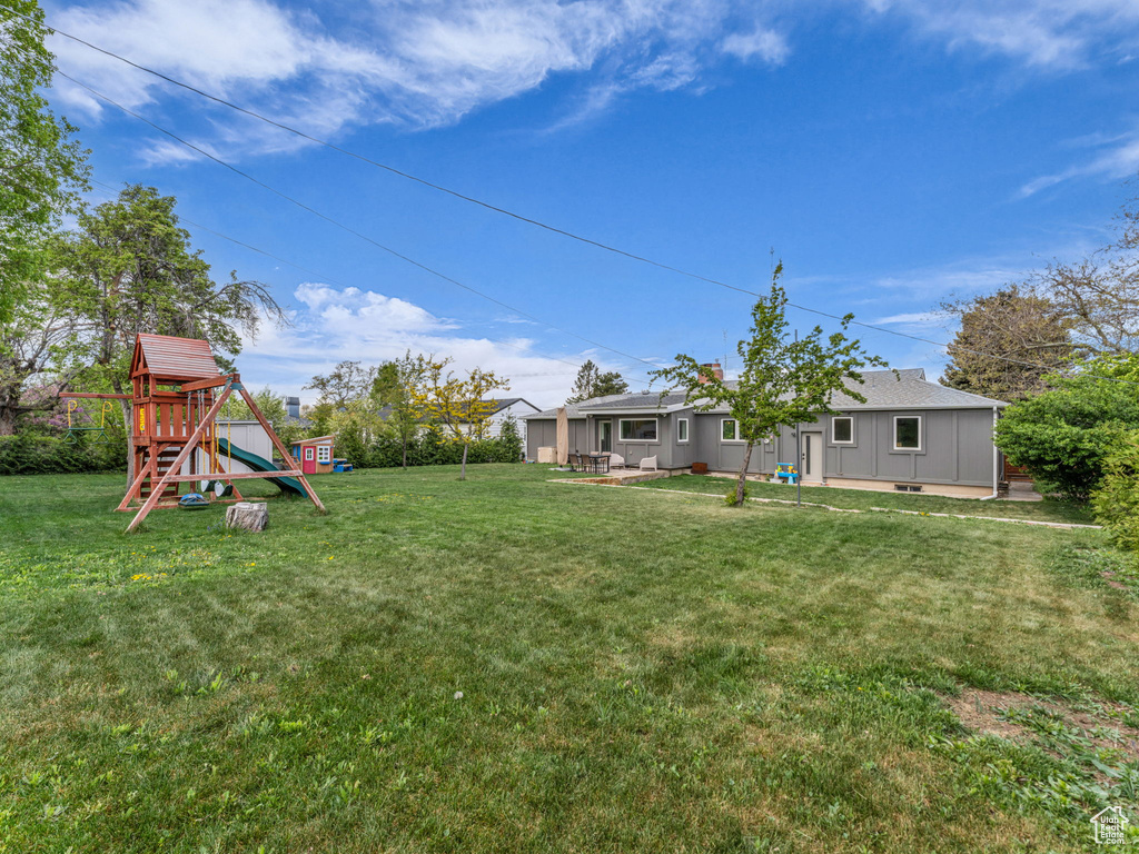 View of yard with a patio area and a playground