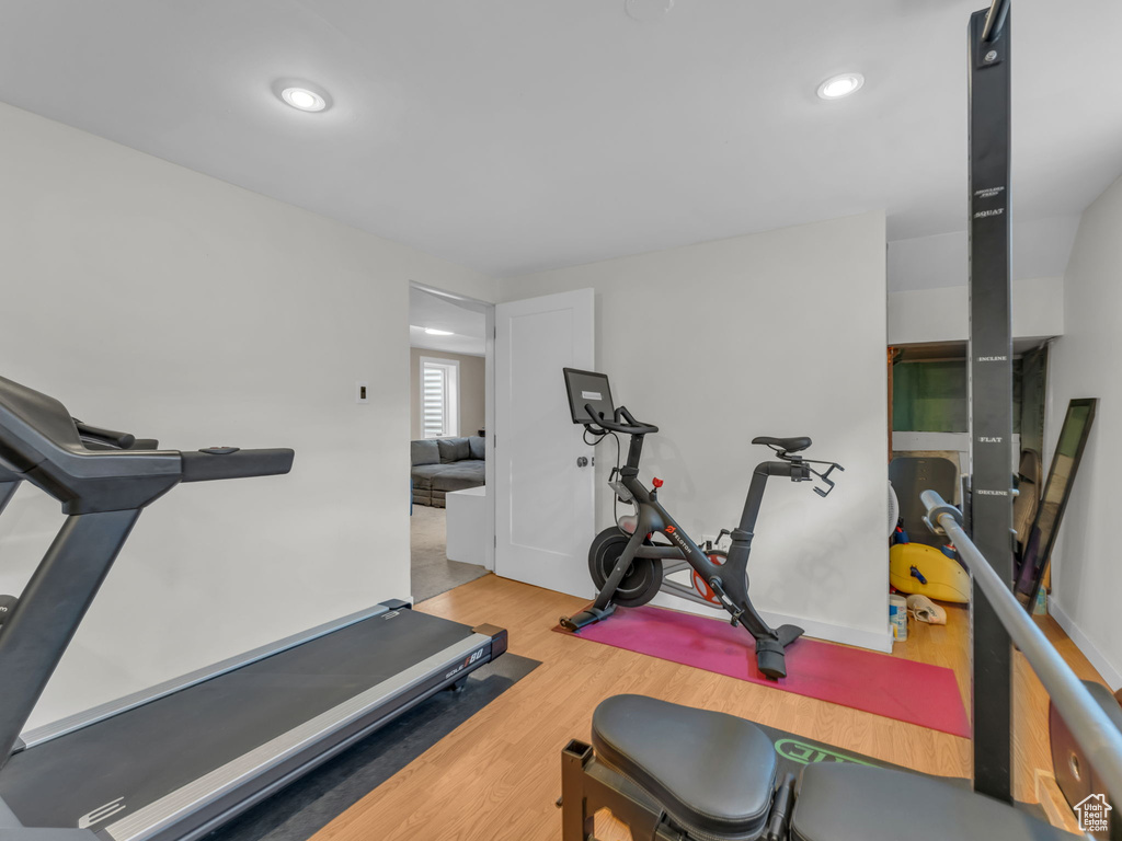 Workout area featuring baseboards, recessed lighting, and wood finished floors