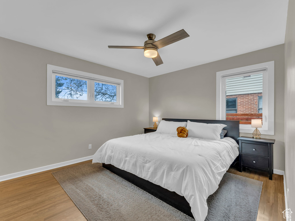 Bedroom featuring baseboards, ceiling fan, and wood finished floors