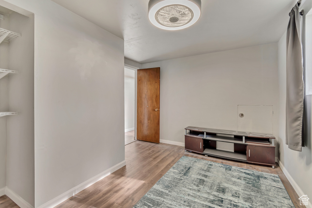 Hallway featuring baseboards and wood finished floors