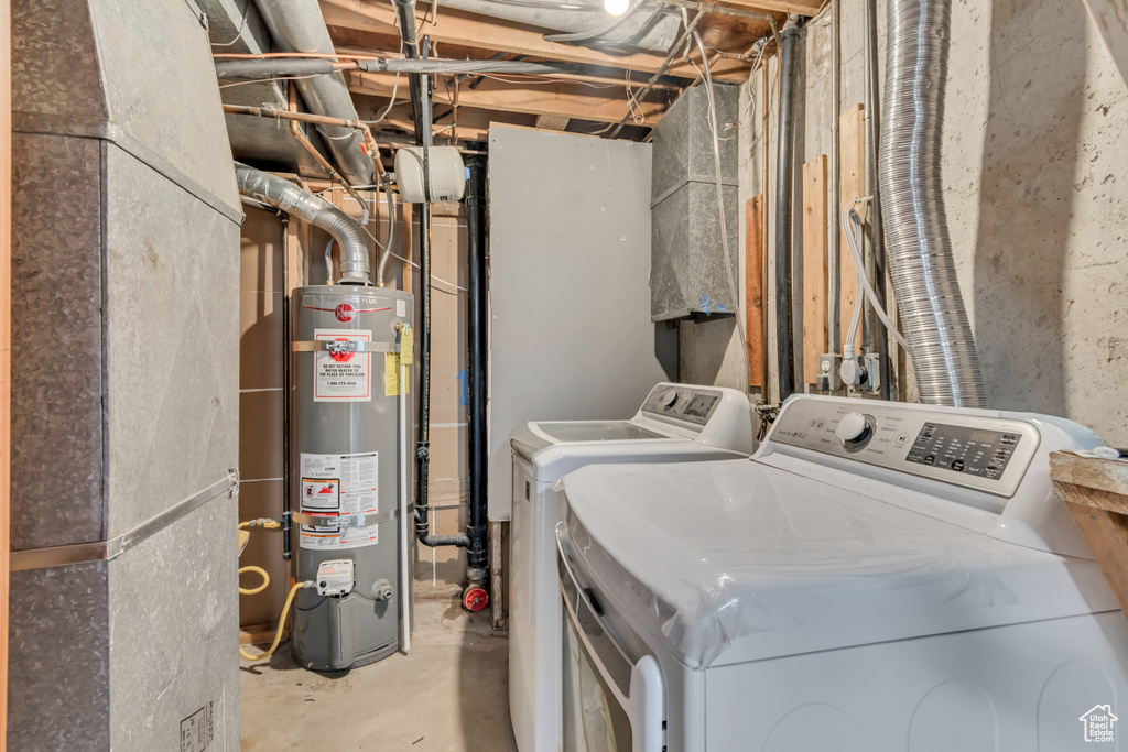 Clothes washing area with laundry area, water heater, and washing machine and clothes dryer