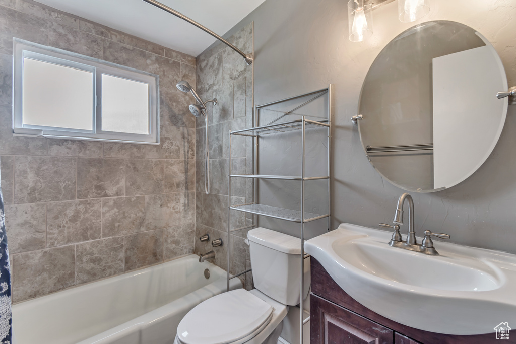 Full bathroom with vanity, toilet, and shower / tub combo