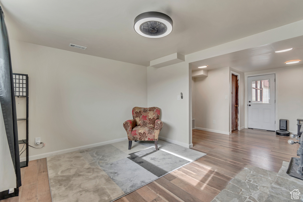 Sitting room featuring baseboards, visible vents, and wood finished floors
