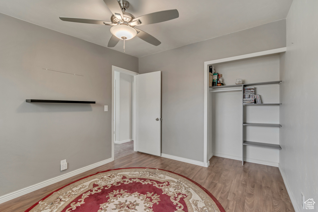 Unfurnished bedroom with baseboards and wood finished floors