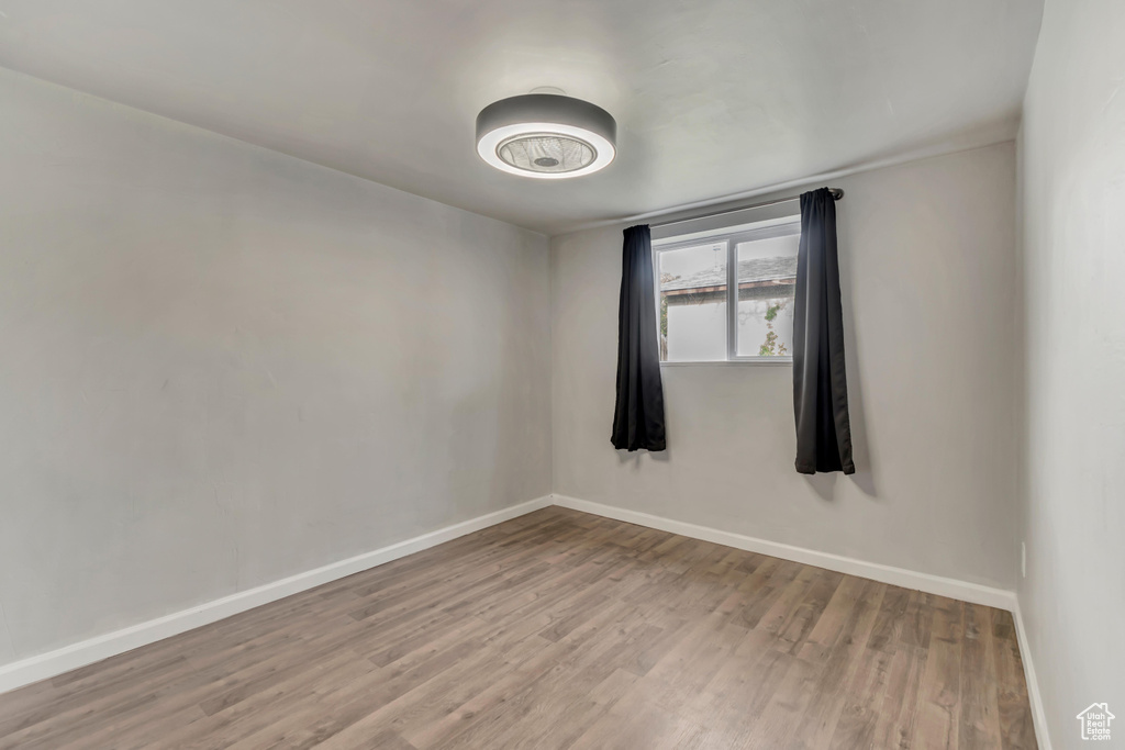 Unfurnished room with baseboards and wood finished floors