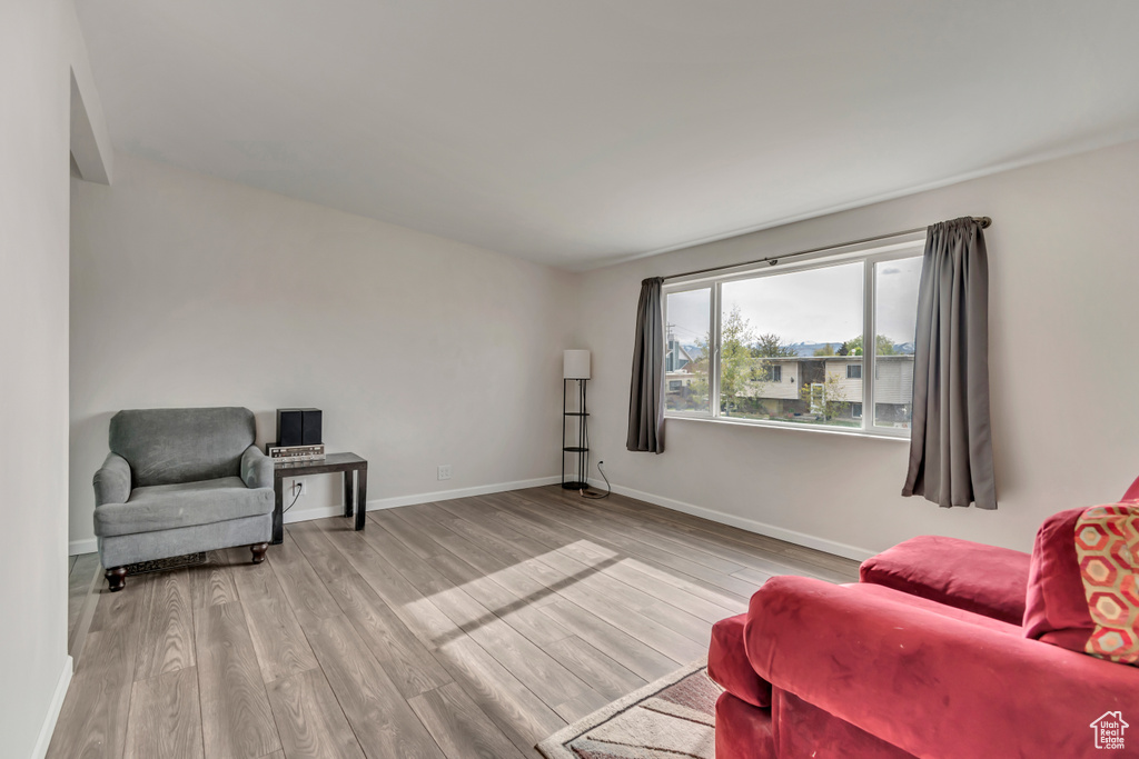 Living area with baseboards and wood finished floors
