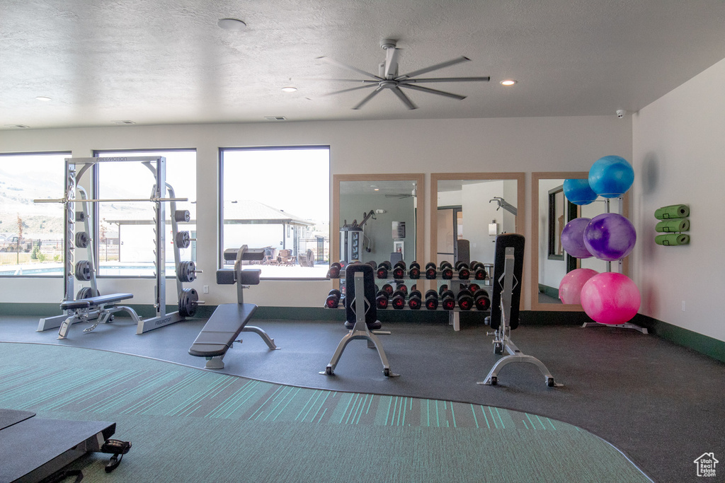 Exercise room with carpet floors, a ceiling fan, baseboards, and recessed lighting