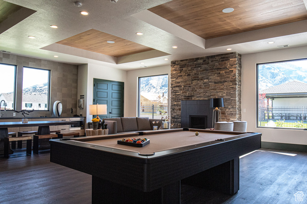 Playroom featuring pool table, a tray ceiling, and wood finished floors