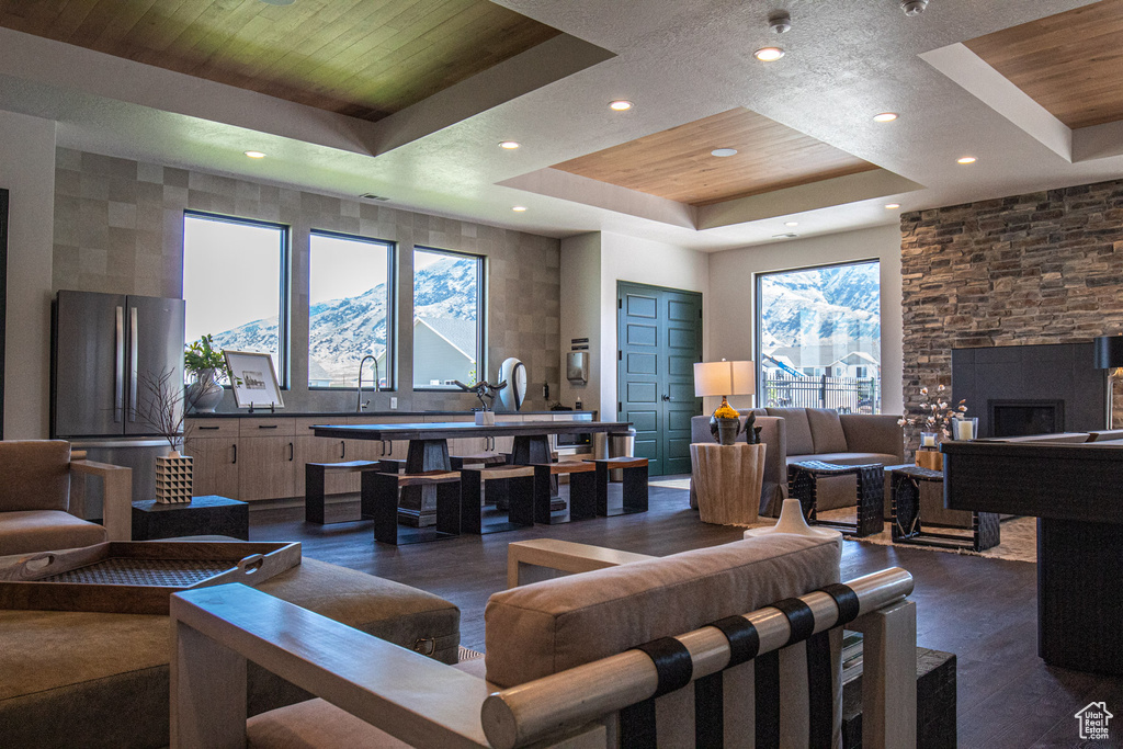 Living area with a raised ceiling, dark wood-style flooring, pool table, and wood ceiling