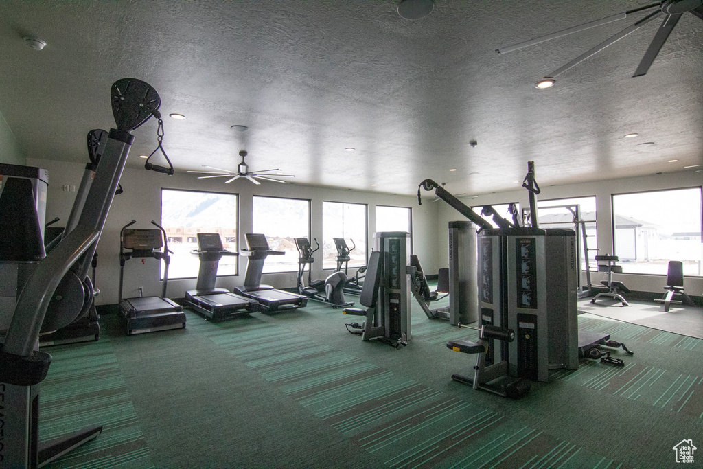 Exercise room with a textured ceiling, ceiling fan, recessed lighting, and carpet