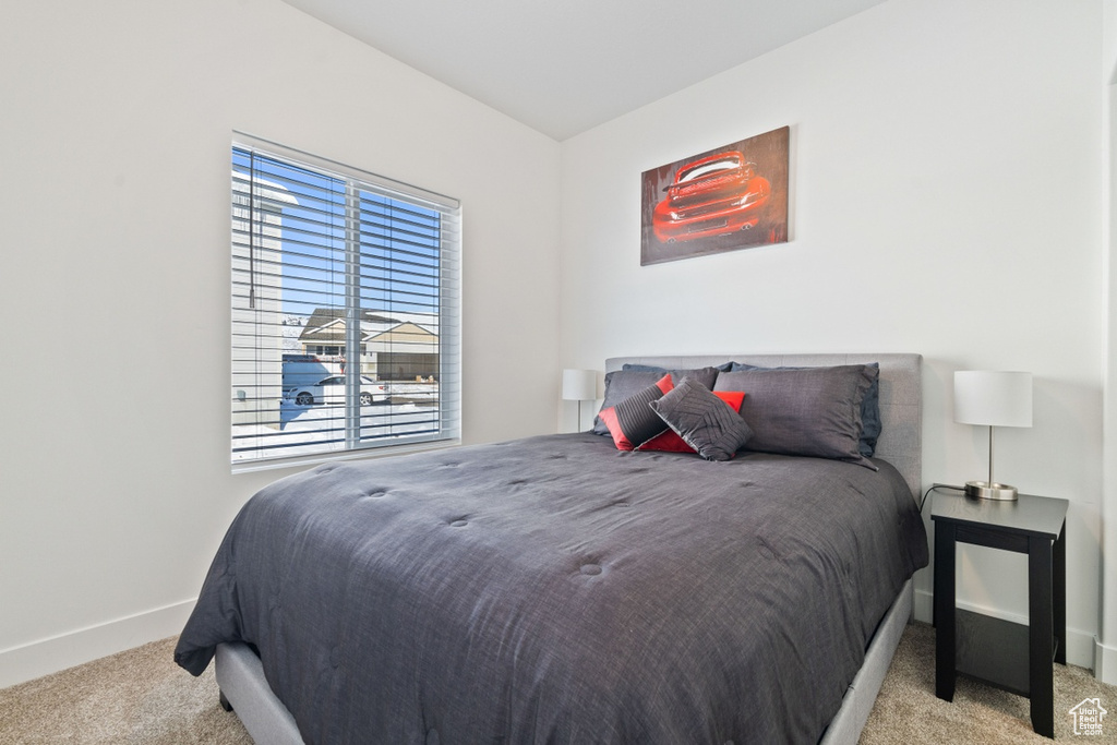 Carpeted bedroom featuring baseboards