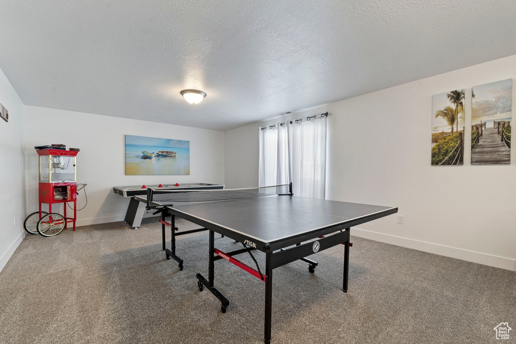 Playroom featuring carpet flooring, a textured ceiling, and baseboards