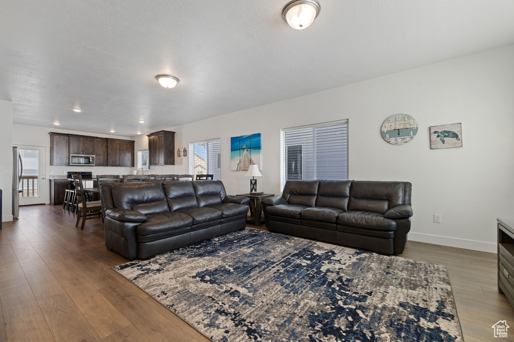 Living room with baseboards and hardwood / wood-style floors