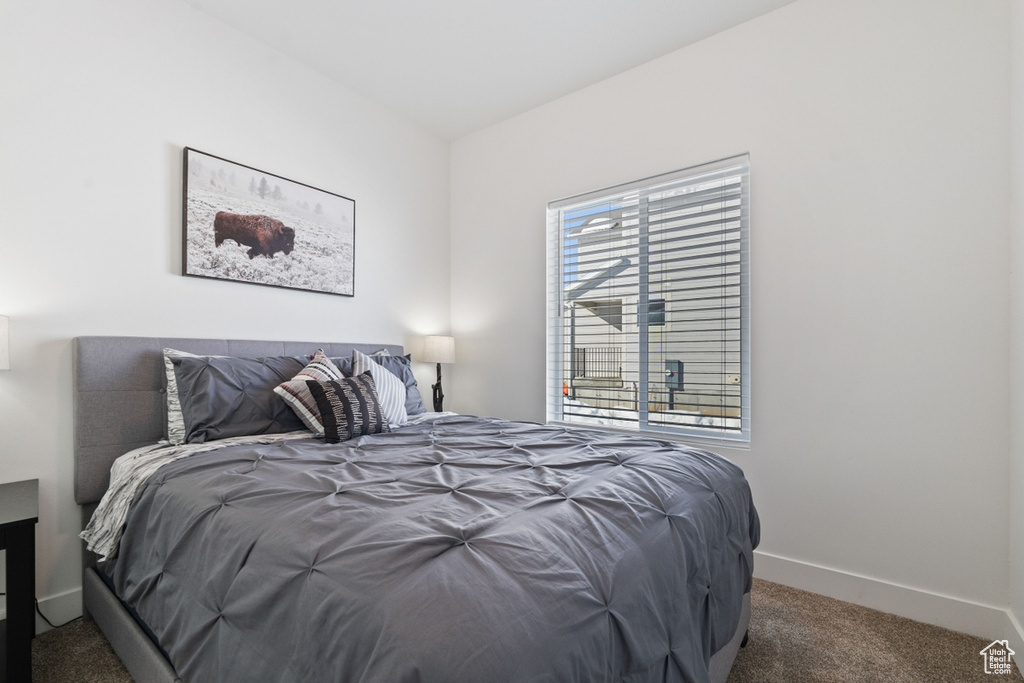 Bedroom with baseboards and carpet flooring
