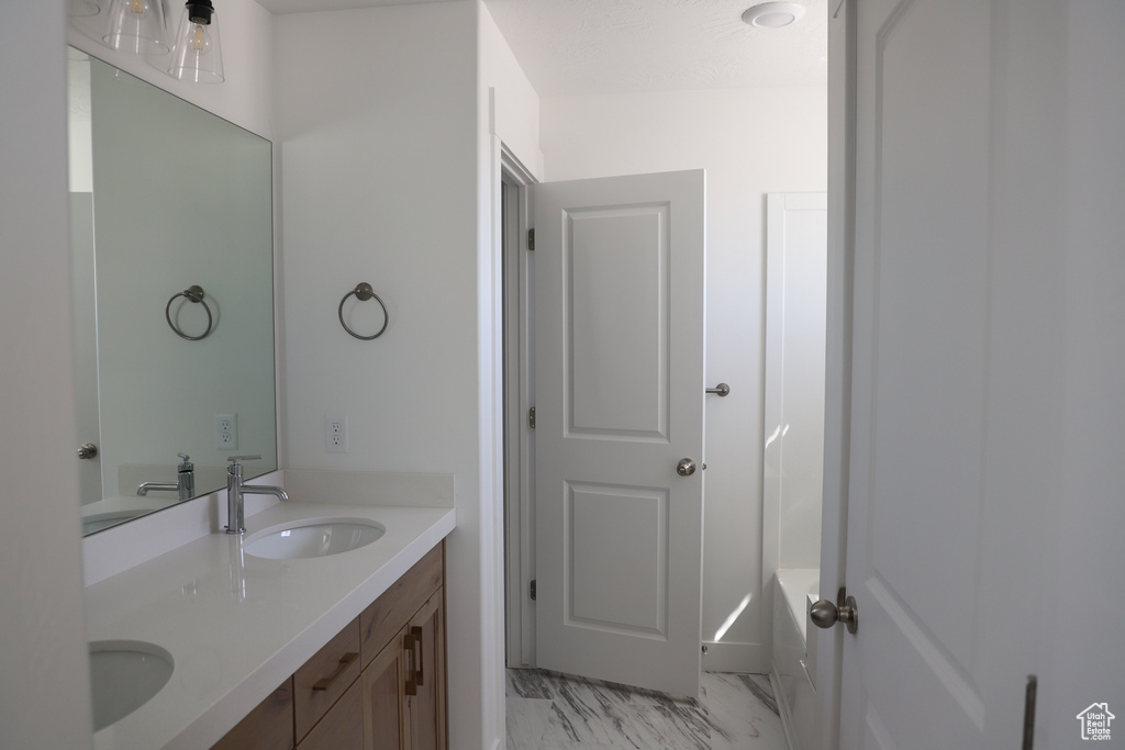Full bathroom with double vanity, a sink, and marble finish floor