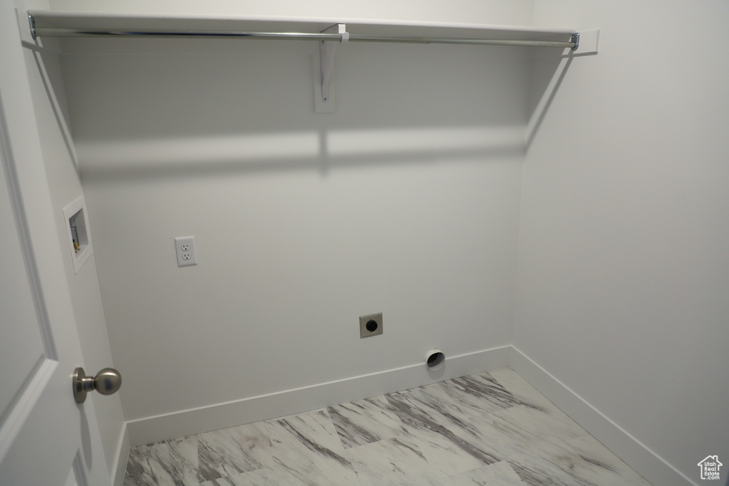 Laundry room with marble finish floor, hookup for an electric dryer, baseboards, and laundry area