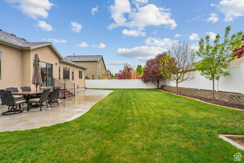 View of yard with a patio and a fenced backyard