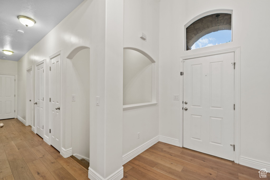Entrance foyer with baseboards and hardwood / wood-style flooring