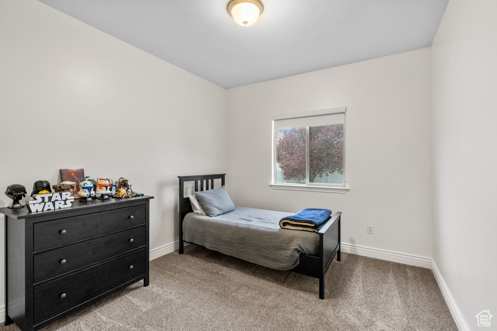 Bedroom featuring carpet floors and baseboards