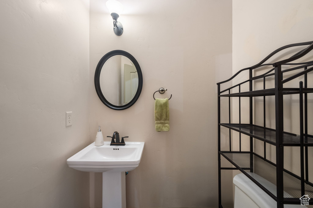 Half bathroom with toilet and a sink