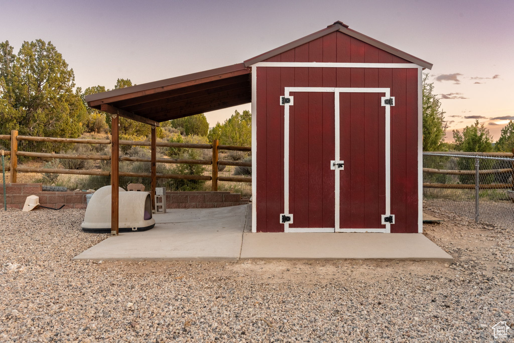 View of shed with a fenced backyard