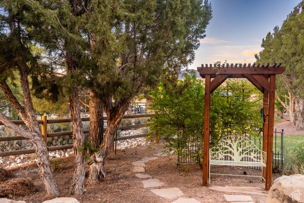 Yard at dusk featuring fence
