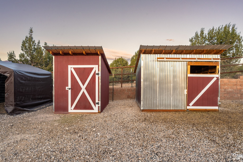 View of shed featuring fence