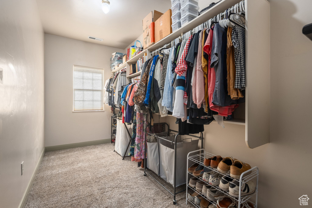 Spacious closet featuring carpet floors and visible vents