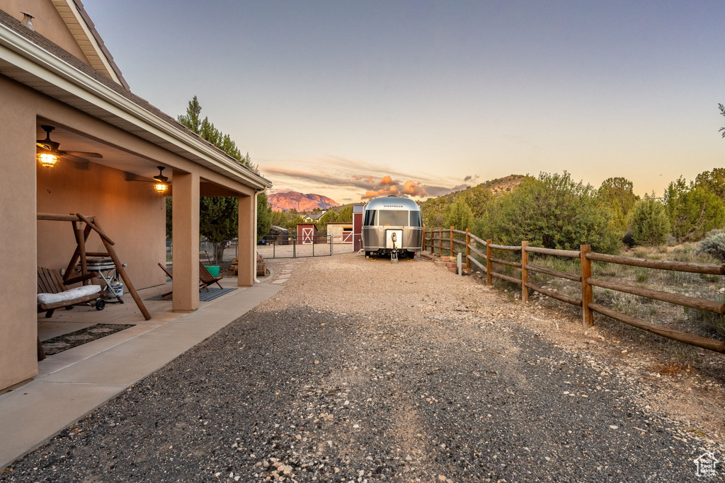 Yard at dusk featuring fence and a patio area