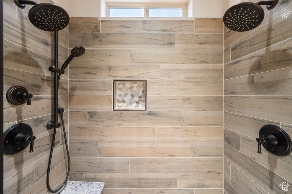 Full bath featuring tiled shower