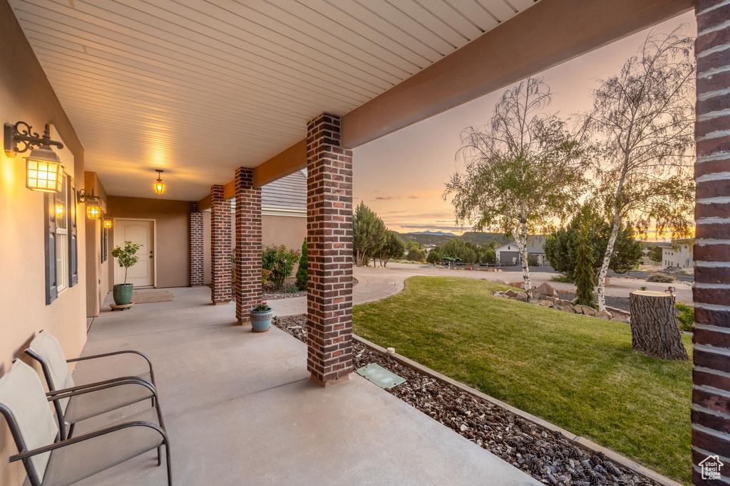 Patio terrace at dusk with a yard