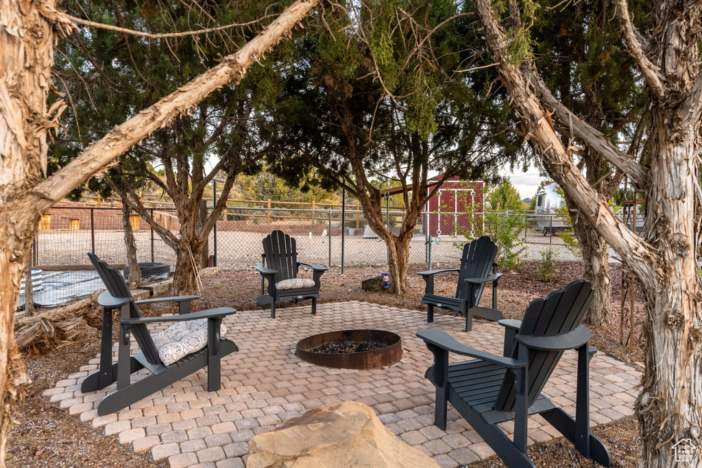 View of patio / terrace with a fire pit and fence