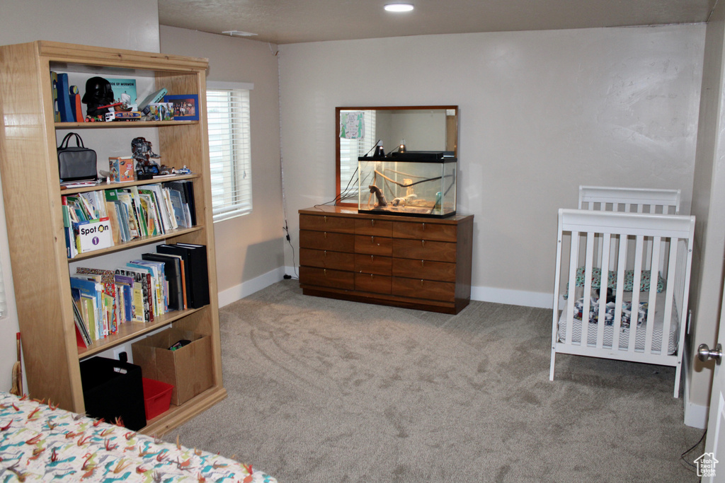 Carpeted bedroom featuring baseboards