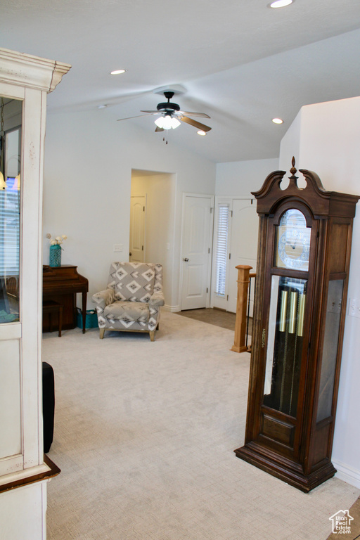 Living area with a ceiling fan, light colored carpet, baseboards, lofted ceiling, and recessed lighting