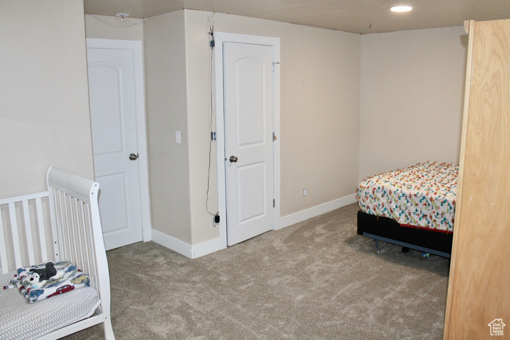 Carpeted bedroom featuring baseboards