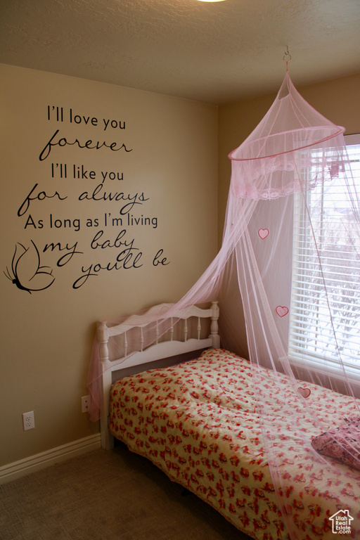 Bedroom with baseboards and carpet