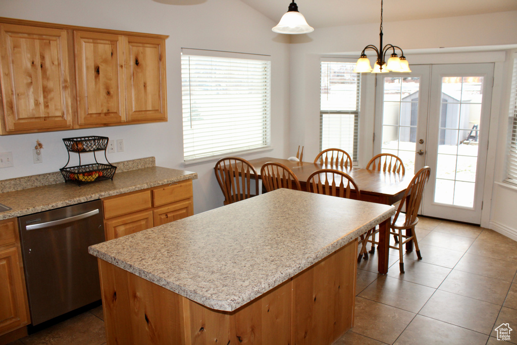 Kitchen featuring light countertops, a wealth of natural light, and dishwasher