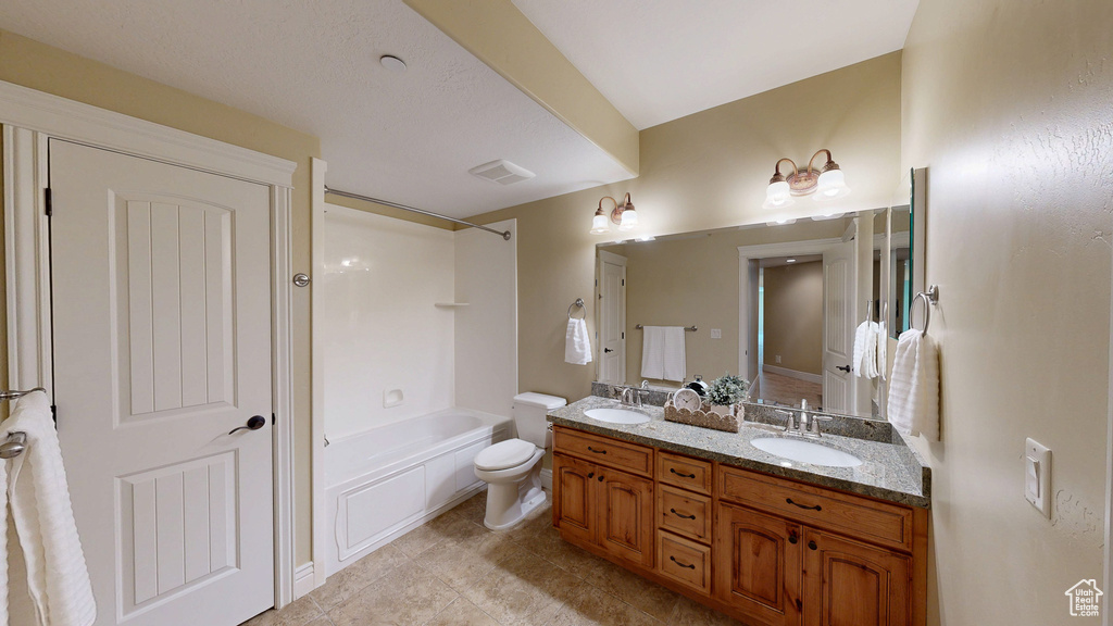 Full bath featuring double vanity, a sink, bathtub / shower combination, and toilet