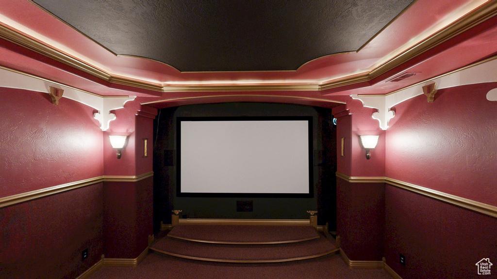 Cinema room with visible vents, decorative columns, and baseboards