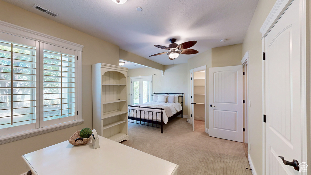 Bedroom featuring baseboards, multiple windows, light colored carpet, and visible vents