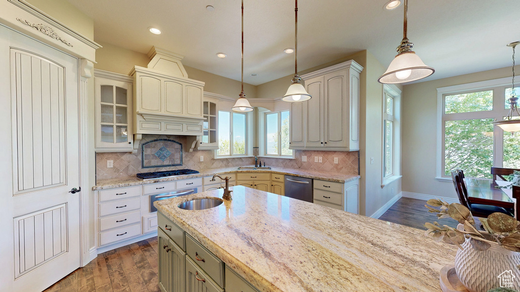 Kitchen featuring gas cooktop, a sink, dishwasher, and a healthy amount of sunlight