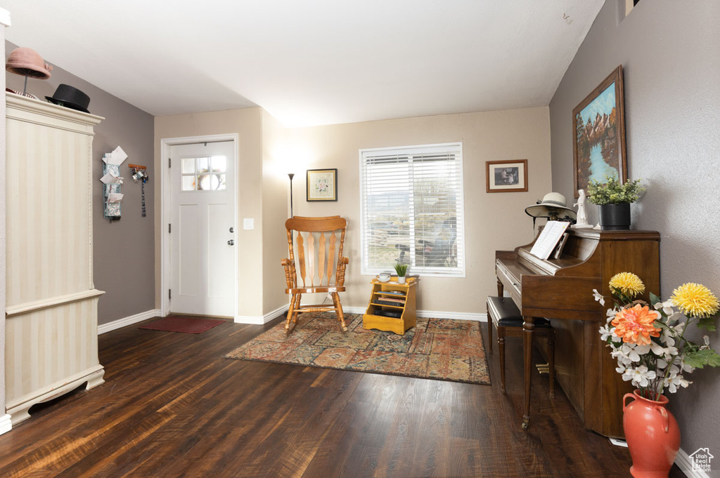 Foyer featuring baseboards and wood finished floors