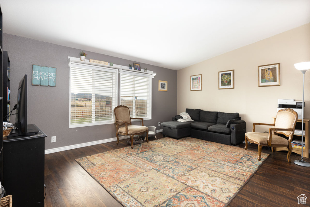 Living area with baseboards and wood finished floors
