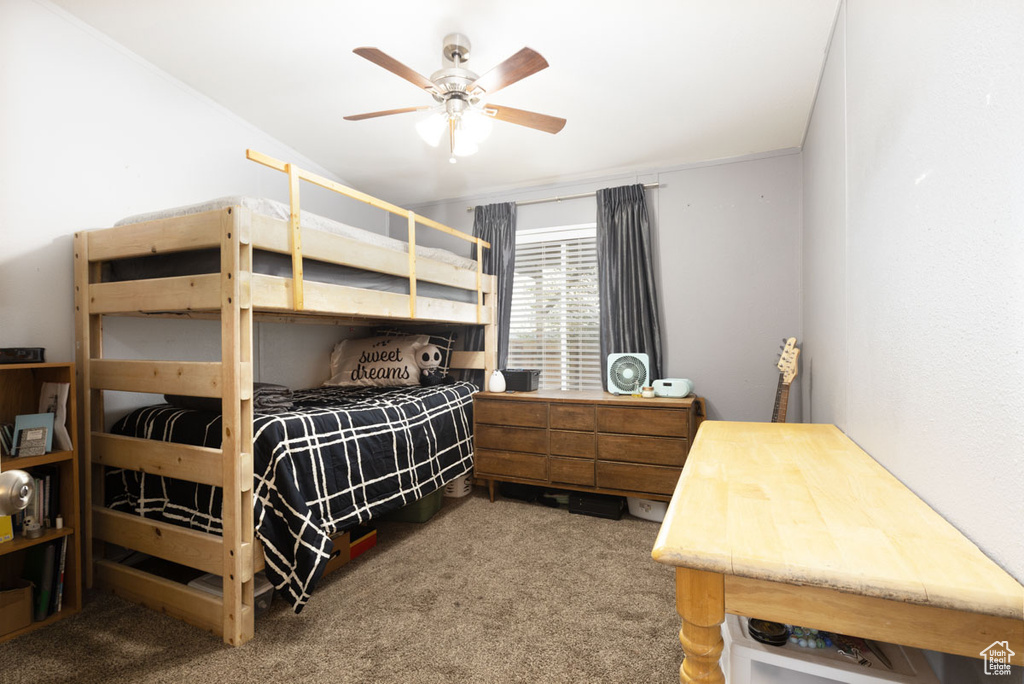 Bedroom featuring a ceiling fan and carpet